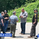 A bunch of cops standing around as Mark Racop looks on.